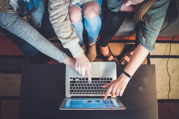 Cross-functional account coordination with teams collaborating on a laptop